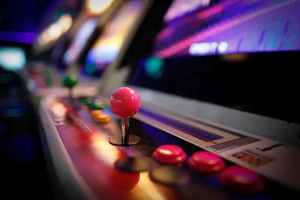 Row of active arcade cabinets being played by visitors