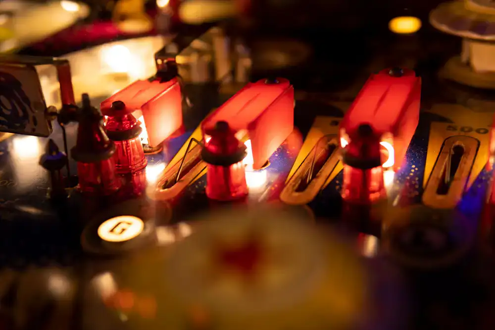 Close up of a glowing pinball table layout
