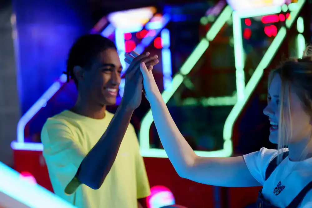 Friends celebrating at the arcade